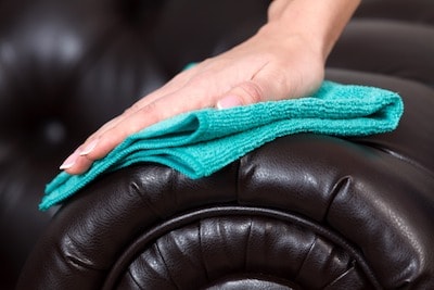 person Restoring a Faded Leather Couch